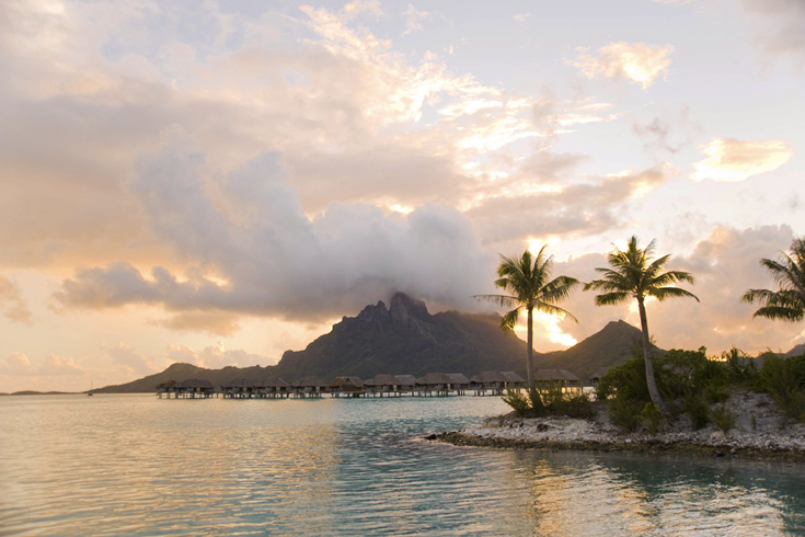 Mount Otemanu and Mount Pahia, Bora Bora’s stunning visual touchstones, rise high above the island’s emerald interior and encircling turquoise seas. These twin stone behemoths are more than 2,000 feet tall and were formed in a violent volcanic eruption eons ago. (Photo Credits: © Helen Havard) 